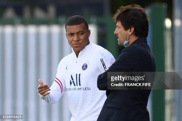 Paris Saint-Germain's Brazilian sporting director Leonardo speaks with Paris Saint-Germain's French forward Kylian Mbappe prior to a training session...