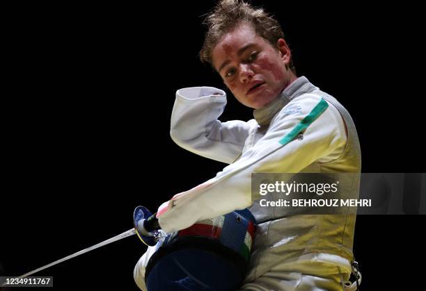 Italy's Beatrice Vio takes off her mask during a video review while competing against Russia's Ludmila Vasileva in the wheelchair fencing women's...