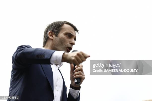 French nationalist party "Les Patriotes" leader Florian Philippot speaks in a mircophone during a rally called by his party against the compulsory...