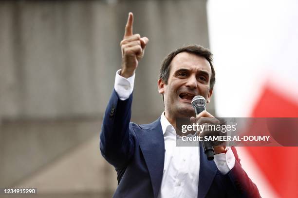 French nationalist party "Les Patriotes" leader Florian Philippot speaks in a mircophone during a rally called by his party against the compulsory...