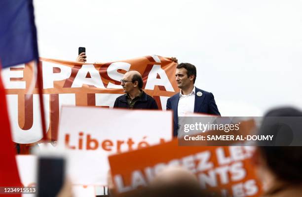 French nationalist party "Les Patriotes" leader Florian Philippot flanked by lawyer Fabrice di Vizio looks on during a rally called by his party...