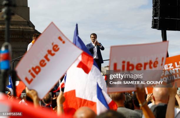 French nationalist party "Les Patriotes" leader Florian Philippot gestures on a platform during a rally called by his party against the compulsory...