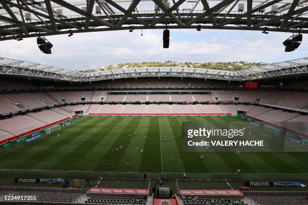 Photograph shows a general view of players competing without supporters during the French L1 "Huis clos" football match between O.G.C Nice and F.C...