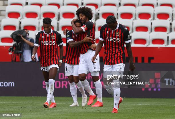 Nice's Dutch forward Justin Kluivert celebrates with teammates after he scored a goal, during the French L1 "Huis clos" football match between O.G.C...