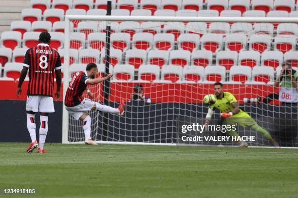 Nice's French forward Amine Gouiri shoots a penalty and scores a third goal during the French L1 "Huis clos" football match between O.G.C Nice and...