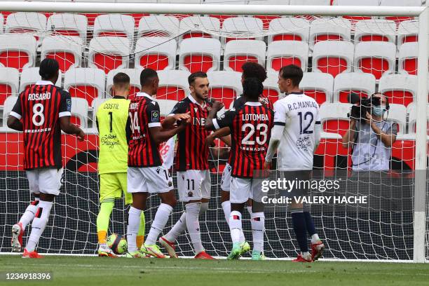 Nice's French forward Amine Gouiri celebrates with teammates after he scored the third goal during the French L1 "Huis clos" football match between...