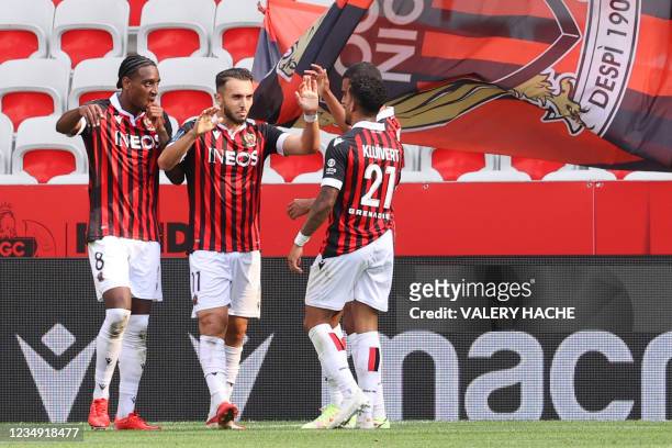 Nice's French forward Amine Gouiri with teammates celebrates after scoring a second goal during the French L1 "Huis clos" football match between...