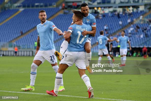 Ciro Immobile with his teammates Pedro and Sergej Milinkovic Savic of SS Lazio celebrates after scoring the opening goal during the Serie A match...