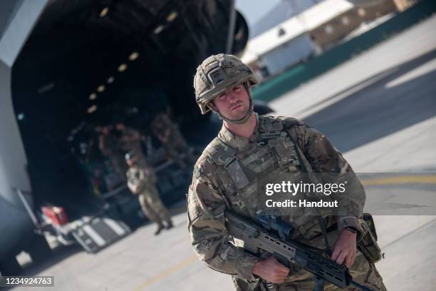 In this handout image provided by the Ministry of Defence, UK military personnel onboard a A400M aircraft depart from Kabul on August 28, 2021 in...