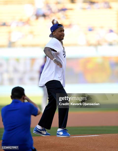 Rapper YG throws the ceremonial first pitch prior to the start of the Colorado Rockies and Los Angeles Dodgers baseball game at Dodger Stadium on...