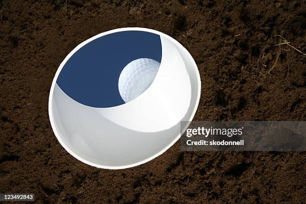 golf ball on the edge of a hole - putting green overhead stock pictures, royalty-free photos & images