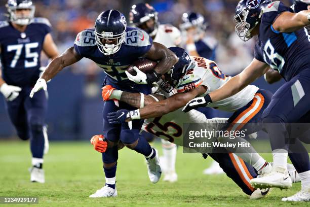Brian Hill of the Tennessee Titans runs the ball during an NFL preseason game by Josh Woods and Caleb Johnson of the Chicago Bears at Nissan Stadium...