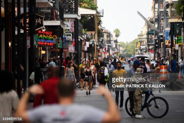 People drink beverages while walking down Bourbon Street in New Orleans, Louisiana on August 28, 2021 before the arrival of Hurricane Ida. - Owners...