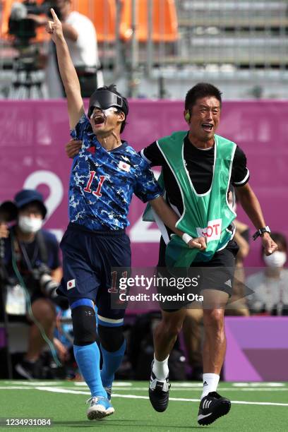 Tomonari Kuroda of Team Japan celebrates scoring his sides first goal with guide Eiji Nakagawa during the Football 5-a-side Preliminary Round Group A...