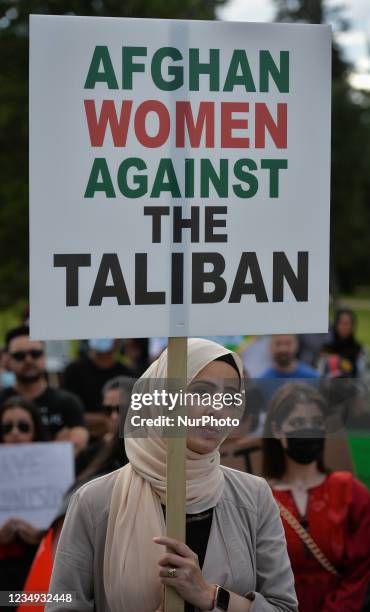 Protester holds a placard that reads 'Afghan Women Against The Taliban'. Members of the local Afghan diaspora, activists and local supporters seen in...