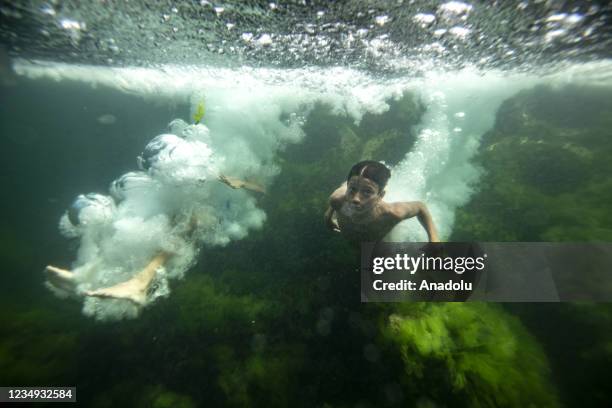 An underwater photo shows children diving in the sea after the mucilage was cleared off Istanbul coasts on August 28, 2021.
