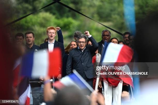 French leftist movement La France Insoumise leader Jean-Luc Melenchon, flanked by LFI MP Adrien Quatennens , raises his fist during a meeting in...