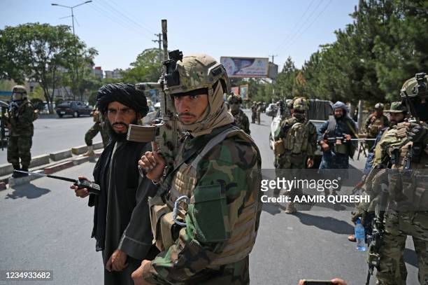 Taliban Fateh fighters, a "special forces" unit, stand guard along a street in Kabul on August 29 as suicide bomb threats hung over the final phase...