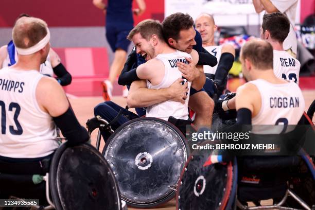 Britain's players celebrate their victory in the wheelchair rugby gold medal match between Britain and the US during the Tokyo 2020 Paralympic Games...