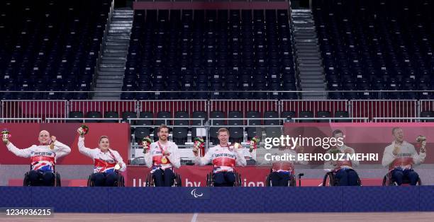 Gold medallists Britain pose on the podium during the medal ceremony of the wheelchair rugby event during the Tokyo 2020 Paralympic Games at the...