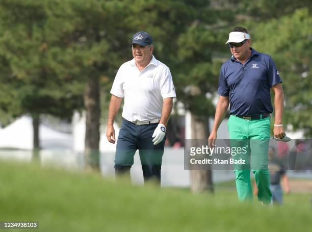 David Frost and Robert Allenby walk along the tenth hole during the second round of The Ally Challenge at Warwick Hills Golf and Country Club on...