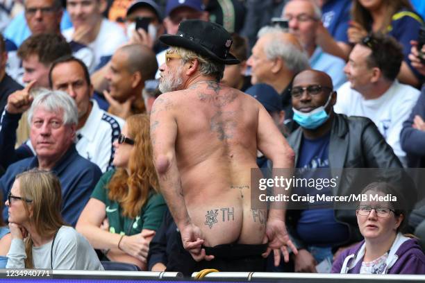 Tattooed Tottenham Hotspur fan shows his backside in appreciation for his team during the Premier League match between Tottenham Hotspur and Watford...