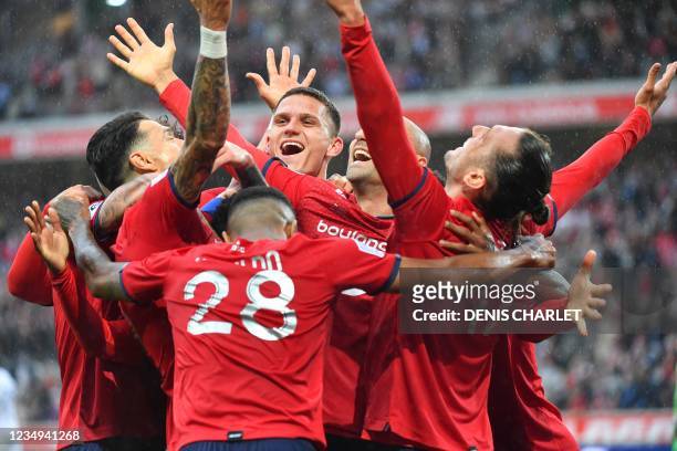 Lille's midfielder Yusuf Yazici celebrates with teammates after he scored a first goal during the French L1 football match between Lille OSC and...