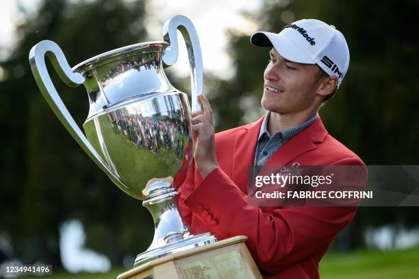 Danish golfer Rasmus Hojgaard poses with his trophy after winning the PGA European Tour golf tournament Omega European Masters on August 29, 2021 in...