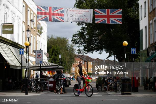 Cyclist rides along Portobello Road on August 29, 2021 in London, England. The annual Caribbean carnival event, which has taken place in the Notting...