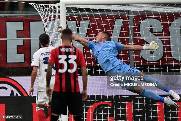 Cagliari's Serbian goalkeeper Boris Radunovic fails to stop a kick by AC Milan's Italian defender Sandro Tonali during the Italian Serie A football...