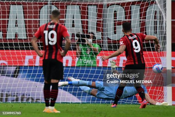 Milan's French forward Olivier Giroud kicks a penalty and scores a fourth goal for his team during the Italian Serie A football match between AC...