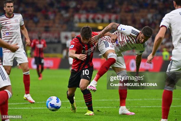 Milan's Spanish midfielder Brahim Diaz challenges Cagliari's Italian midfielder Alessandro Deloia , during the Italian Serie A football match between...