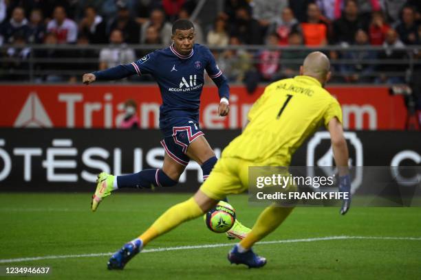 Paris Saint-Germain's French forward Kylian Mbappe scores his team's second goal past Reims' Serbian goalkeeper Predrag Rajkovic during the French L1...