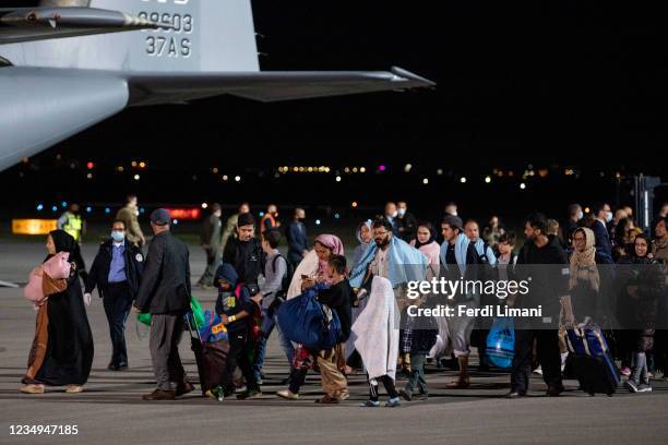 Afghan evacuees arrive to the special terminal at the Pristina International Airport onboard a US Air Force cargo plane on August 29, 2021 in...