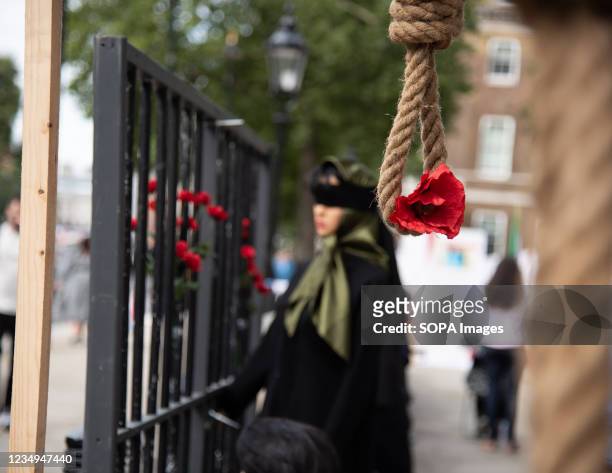 An installation of hanging noose and red flower at Whitehall drawing attention to the 1988 Massacre of the Political Prisoners in Iran. A...