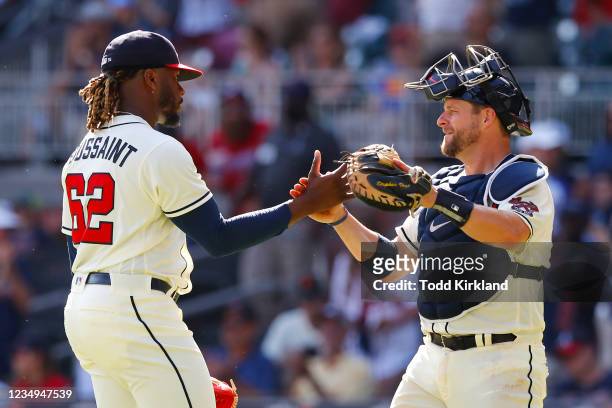 Touki Toussaint of the Atlanta Braves reacts with Stephen Vogt at the conclusion of their 9-0 victory over the San Francisco Giants at Truist Park on...