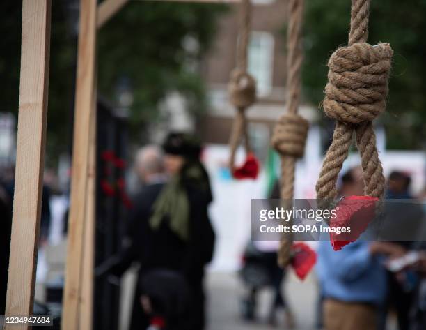 An installation of hanging noose and red flower at Whitehall drawing attention to the 1988 Massacre of the Political Prisoners in Iran. A...