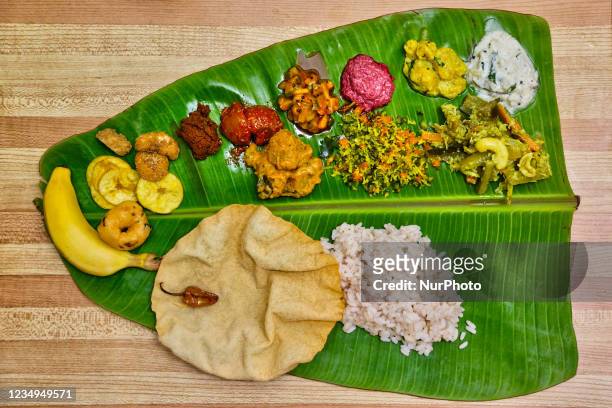 Traditional Sadhya meal served on a banana leaf in Toronto, Ontario, Canada during the Onam Festival on August 28, 2021. Sadhya consists of a variety...