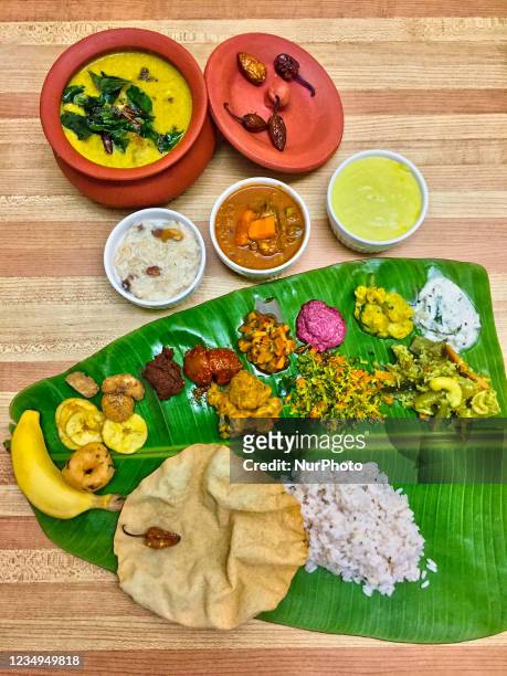 Traditional Sadhya meal served on a banana leaf in Toronto, Ontario, Canada during the Onam Festival on August 28, 2021. Sadhya consists of a variety...