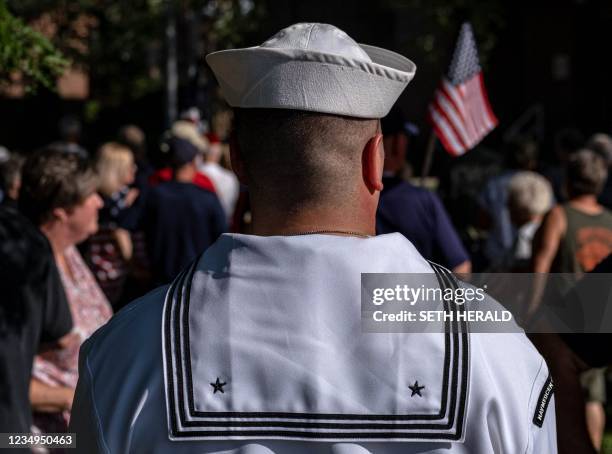 Navy service member attends a vigil for Navy Corpsman Maxton "Max" W. Soviak at Edison Middle School in Berlin Heights, Ohio on August 29, 2021. -...