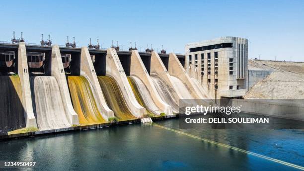This picture taken on July 26, 2021 shows an aerial view of the closed sluice gates at the 1973 Tabqa Dam along the Euphrates river in Raqa province...