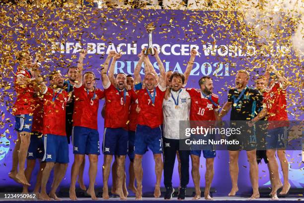 Anton Shkarin of Football Union Of Russia lifts up the trophy to celebrate world championship with his teammates during the prize-giving ceremony of...