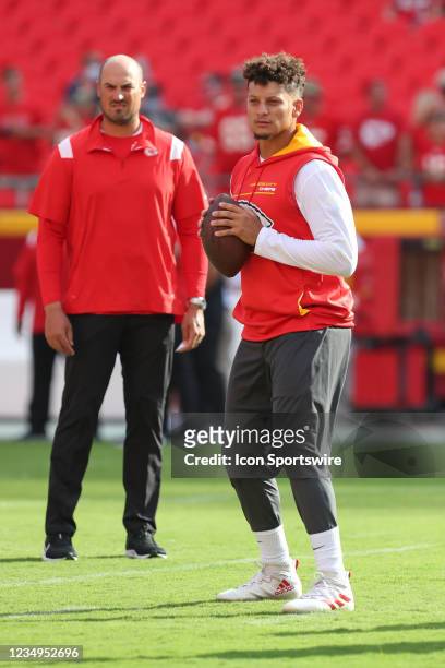 Kansas City Chiefs quarterback Patrick Mahomes warms up under the watchful eye of quarterbacks coach Mike Kafka before an NFL preseason game between...