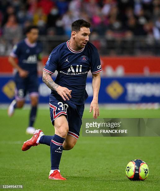 Paris Saint-Germain's Argentinian forward Lionel Messi plays the ball during the French L1 football match between Stade de Reims and Paris...