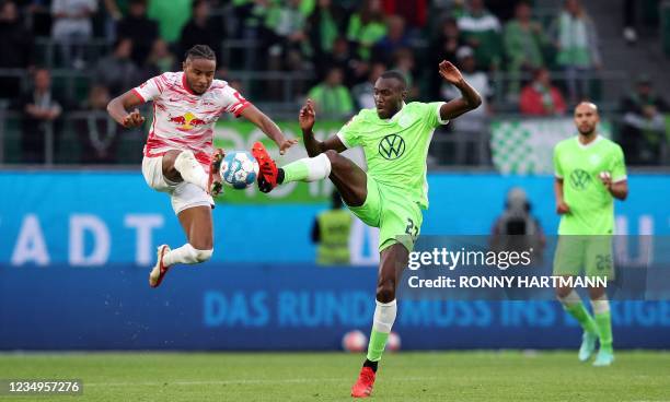 Leipzig's French midfielder Christopher Nkunku and Wolfsburg's French midfielder Josuha Guilavogui vie for the ball during the German first division...