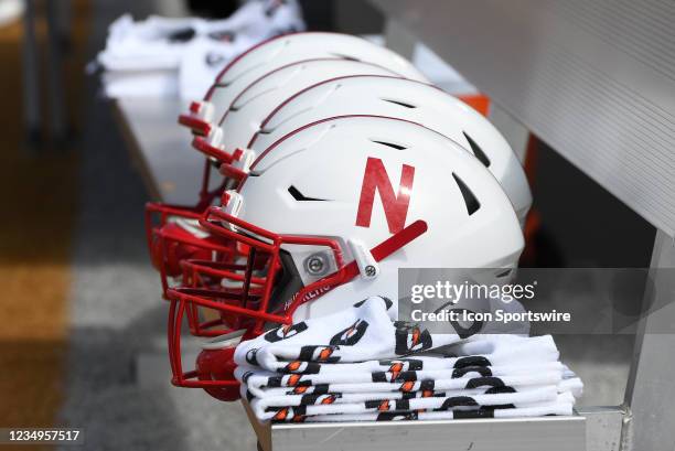 Nebraska Cornhuskers helmets are lined up next to towels on the team bench before the start of the Big Ten Conference college football game between...