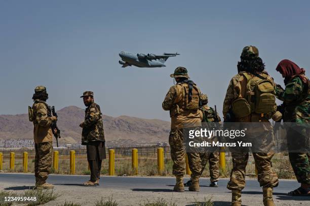 Globemaster takes off as Taliban fighters secure the outer perimeter, alongside the American controlled side of of the Hamid Karzai International...