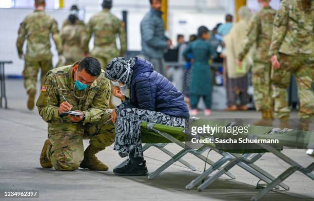 Recently-arrived refugees from Afghanistan waiting for medic support at a temporary camp at the U.S. Army's Rhine Ordnance Barracks , where they are...