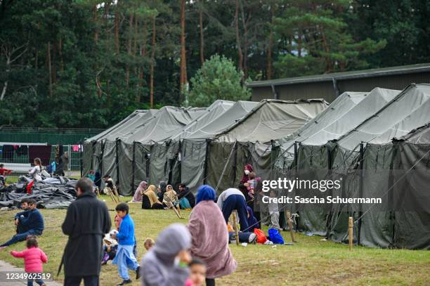 Recently-arrived refugees from Afghanistan seen at a temporary camp at the U.S. Army's Rhine Ordnance Barracks , where they are being temporarily...