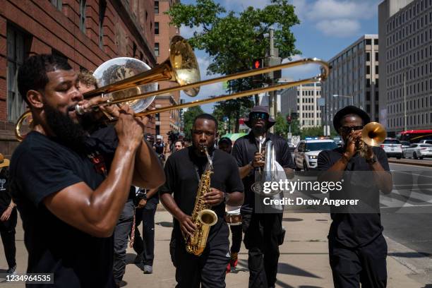 Protestors, including a New Orleans style brass band, protest the fossil fuel industry lobbying firms near Capitol Hill on August 30, 2021 in...
